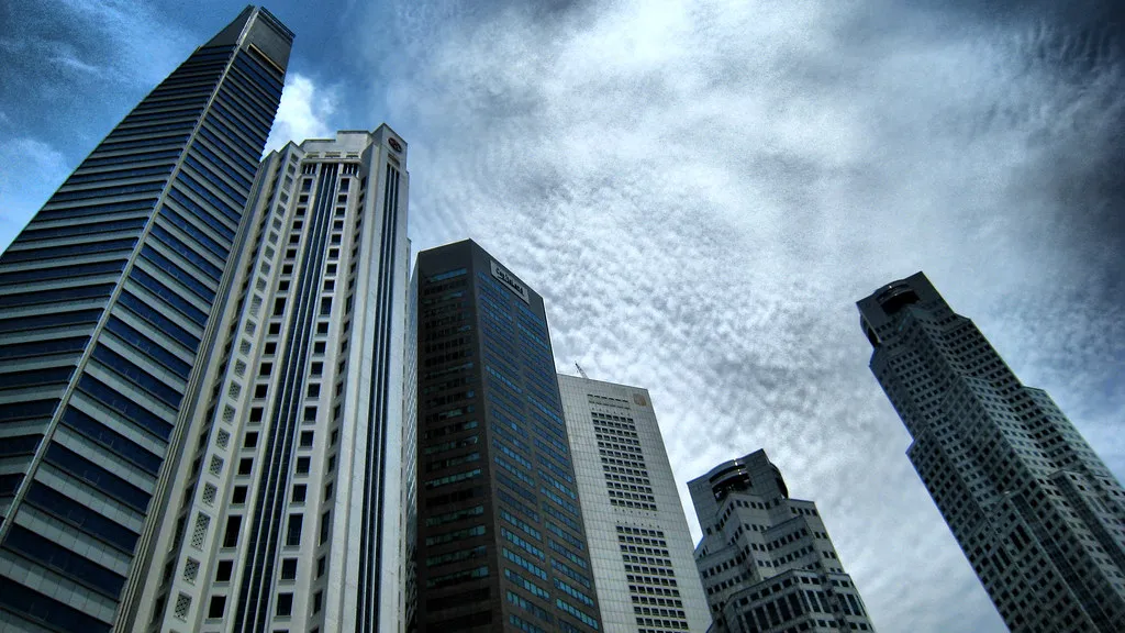 Financial-district skyscrapers rising against a cloudy sky